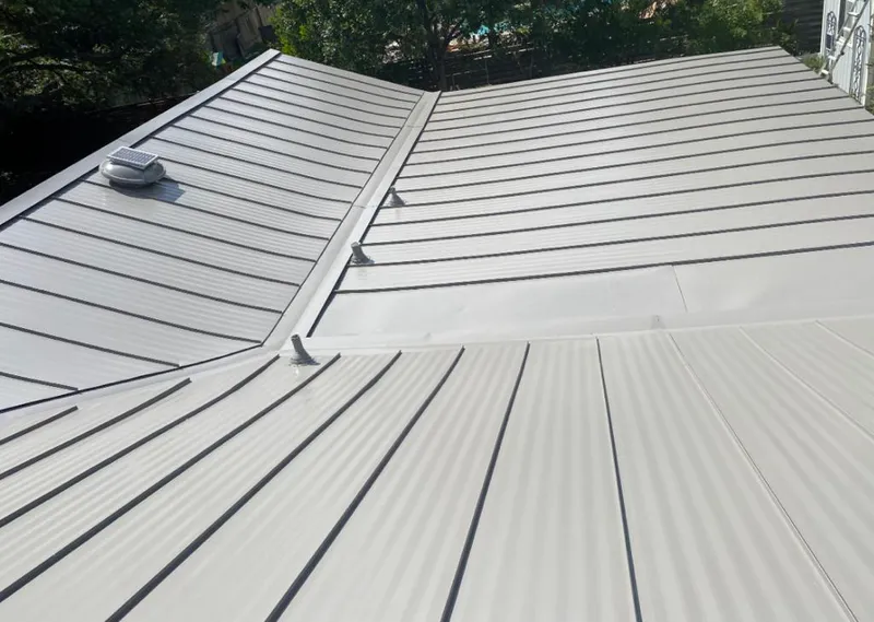 Solar attic fan installed on a metal roof for Roof Ventilation in Irvington