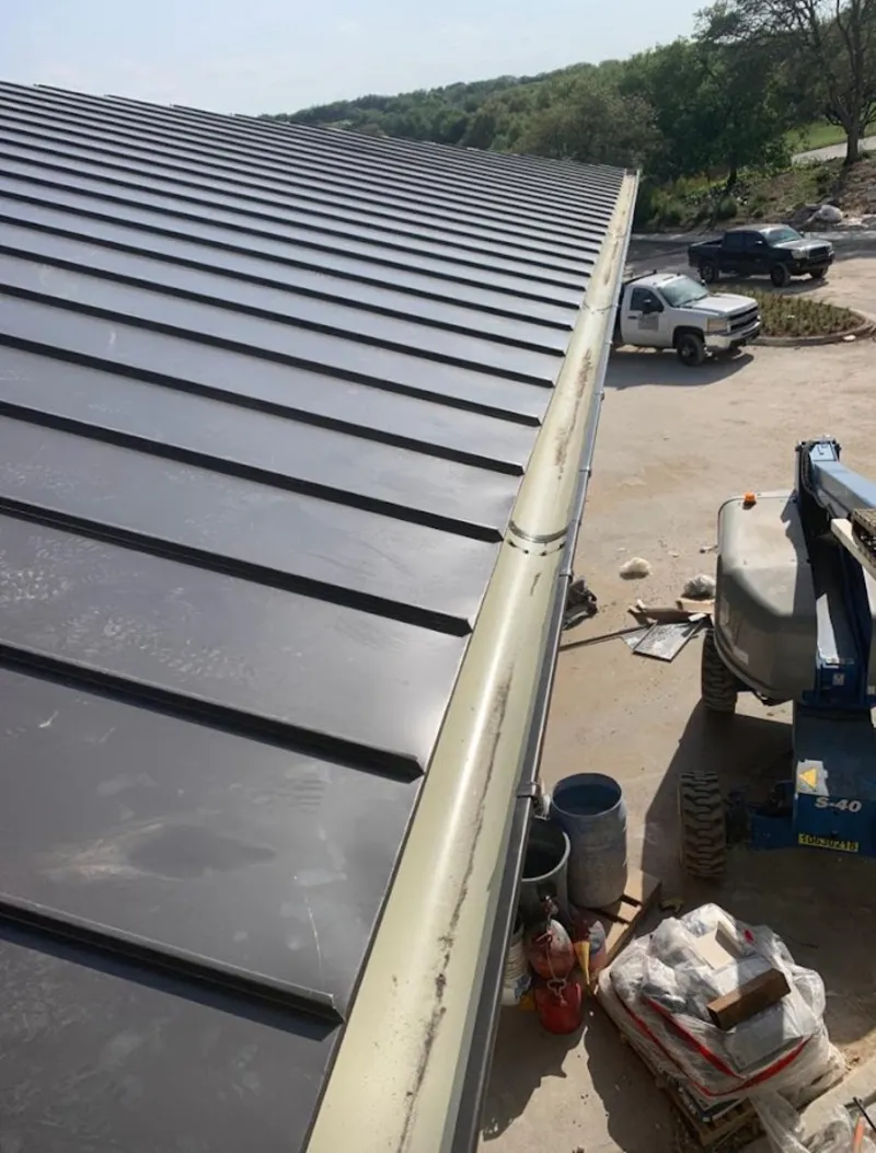 Standing seam panel and gutter detail on a metal roofing jobsite in Irvington